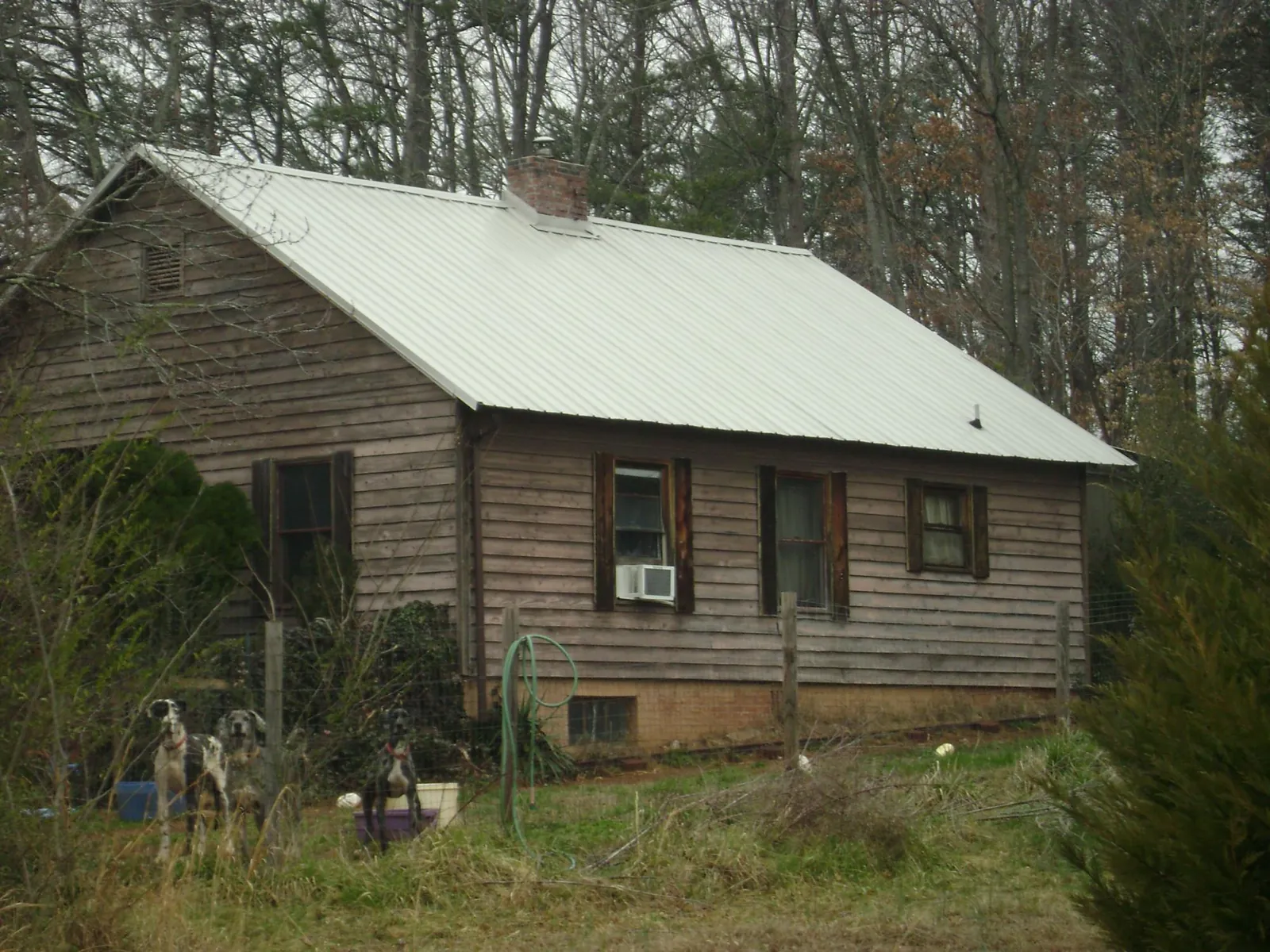 White metal roof on an old wood sided farmhouse, from a Metal Roof Installation job in Tomkins Cove